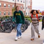 NMU stock photo of students walking on campus