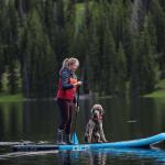 Mathewson practicing self-care on a paddleboard with her standard poodle (Top O' the World student newspaper photo)