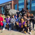 Reunion attendees pose for a photo in front of the Wildcat statue.