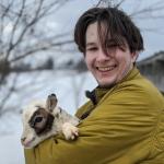 Tucker McLain holding a baby goat named Little Snickers.