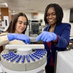 Student Sabrina Mata and visiting AAUW research fellow Justine Nakintu in the NMU Chemistry lab.